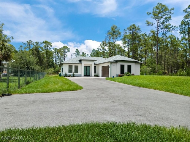 4325 47th Ave NE, Naples, FL 34120 - prairie-style house featuring driveway, a garage, and stucco siding
