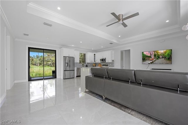 4325 47th Ave NE, Naples, FL 34120 - living area featuring a tray ceiling, ceiling fan, crown molding, light marble finish flooring, and recessed lighting