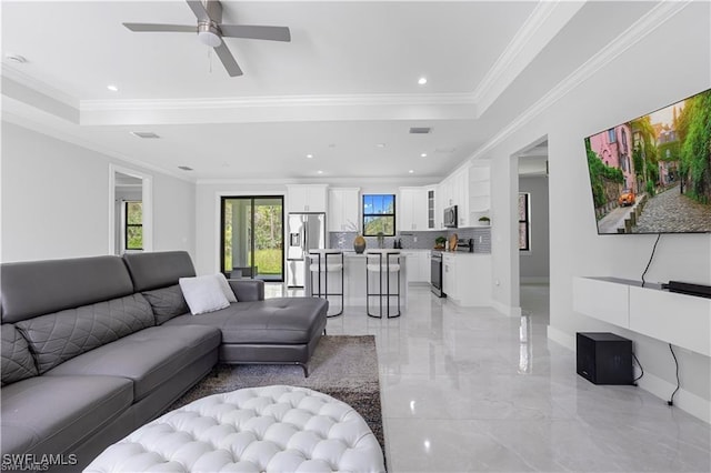 4325 47th Ave NE, Naples, FL 34120 - living room with light marble finish floors, ceiling fan, crown molding, a raised ceiling, and recessed lighting
