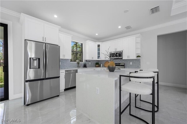 4325 47th Ave NE, Naples, FL 34120 - kitchen featuring appliances with stainless steel finishes, open shelves, backsplash, white cabinets, and ornamental molding