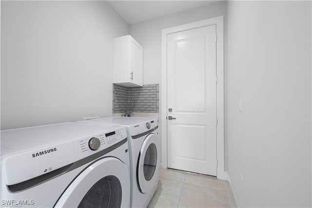 4325 47th Ave NE, Naples, FL 34120 - washroom with cabinet space, washer and clothes dryer, and light tile patterned floors
