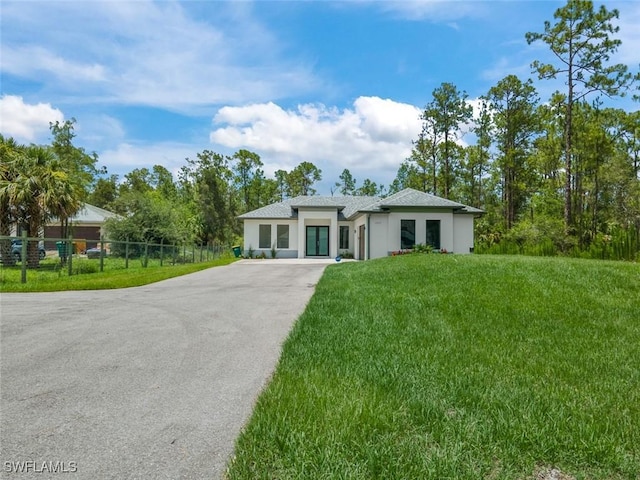 4325 47th Ave NE, Naples, FL 34120 - prairie-style house featuring asphalt driveway and stucco siding