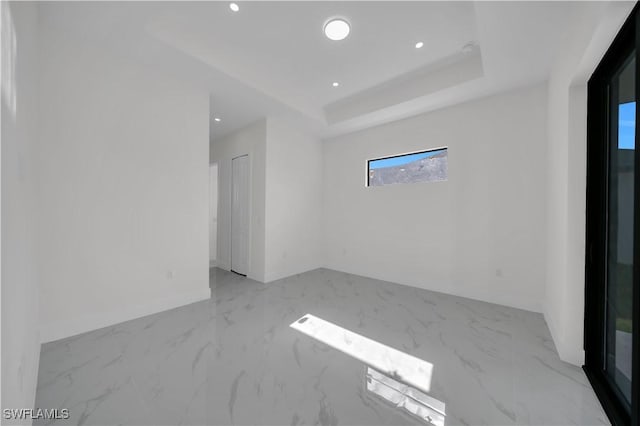 3513 36th St SW, Lehigh Acres, FL 33976 - unfurnished room with marble finish flooring, recessed lighting, and a raised ceiling