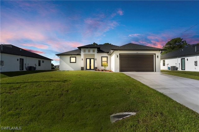3513 36th St SW, Lehigh Acres, FL 33976 - prairie-style house featuring stucco siding, driveway, a garage, and a front lawn