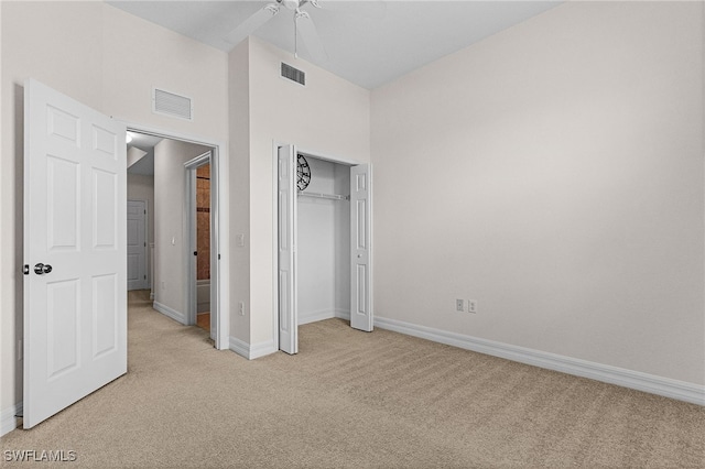 16142 Via Solera Cir Unit 103, Fort Myers, FL 33908 - unfurnished bedroom with light colored carpet, a closet, ceiling fan, and a towering ceiling
