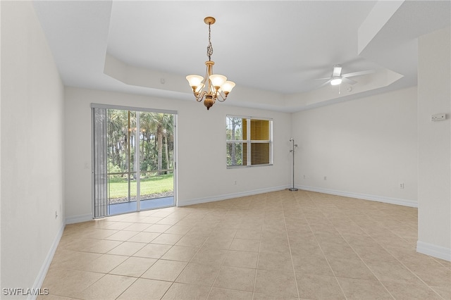 16142 Via Solera Cir Unit 103, Fort Myers, FL 33908 - empty room with a raised ceiling, a chandelier, a ceiling fan, and light tile patterned floors