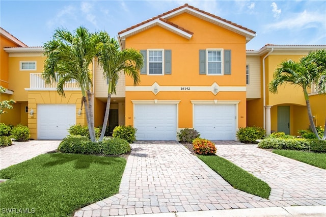 16142 Via Solera Cir Unit 103, Fort Myers, FL 33908 - view of property with stucco siding, an attached garage, and driveway