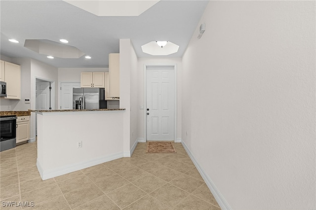 16142 Via Solera Cir Unit 103, Fort Myers, FL 33908 - kitchen with appliances with stainless steel finishes, recessed lighting, a peninsula, and dark stone countertops
