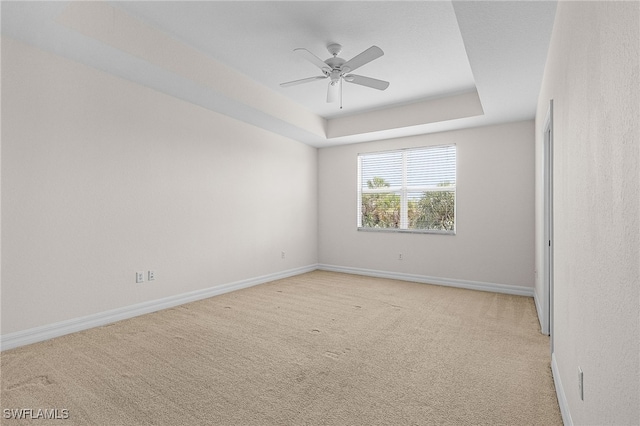 16142 Via Solera Cir Unit 103, Fort Myers, FL 33908 - unfurnished room with light colored carpet, ceiling fan, and a tray ceiling