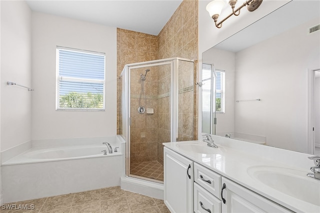 16142 Via Solera Cir Unit 103, Fort Myers, FL 33908 - bathroom with a garden tub, a stall shower, double vanity, and tile patterned flooring