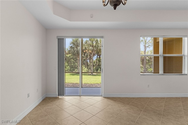 16142 Via Solera Cir Unit 103, Fort Myers, FL 33908 - empty room with light tile patterned floors and a chandelier