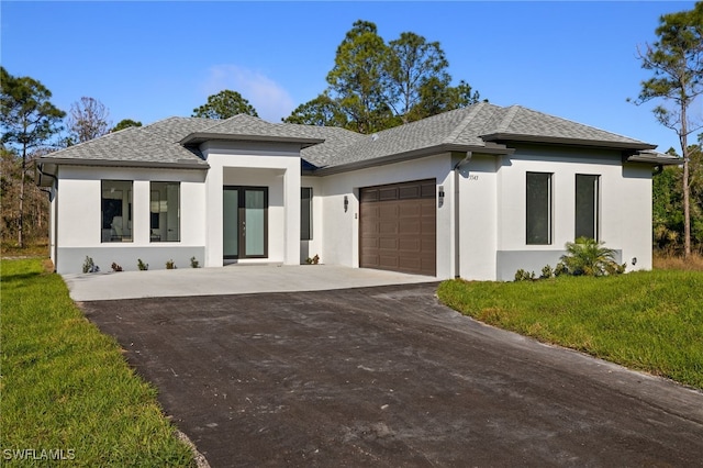 3587 18th Ave SE, Naples, FL 34117 - prairie-style home with driveway, stucco siding, a garage, and a front lawn