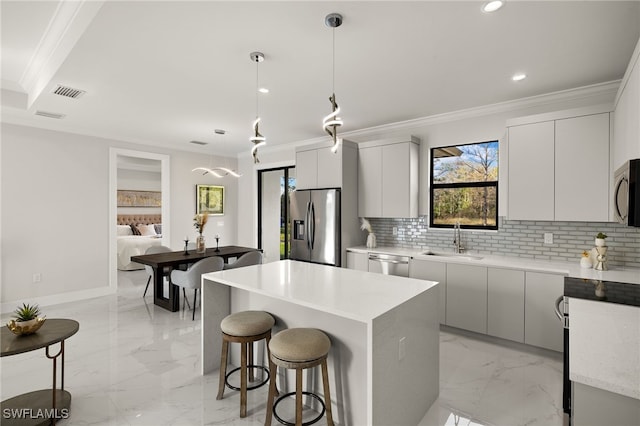 3587 18th Ave SE, Naples, FL 34117 - kitchen featuring stainless steel appliances, modern cabinets, light marble finish floors, crown molding, and tasteful backsplash