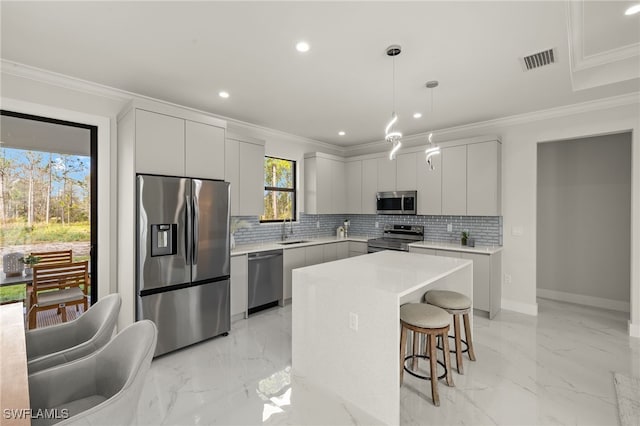 3587 18th Ave SE, Naples, FL 34117 - kitchen with stainless steel appliances, tasteful backsplash, a kitchen breakfast bar, recessed lighting, and modern cabinets