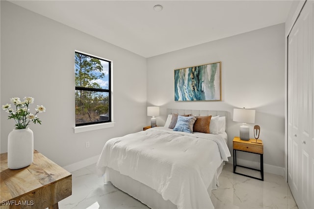 3587 18th Ave SE, Naples, FL 34117 - bedroom with light marble finish flooring and a closet