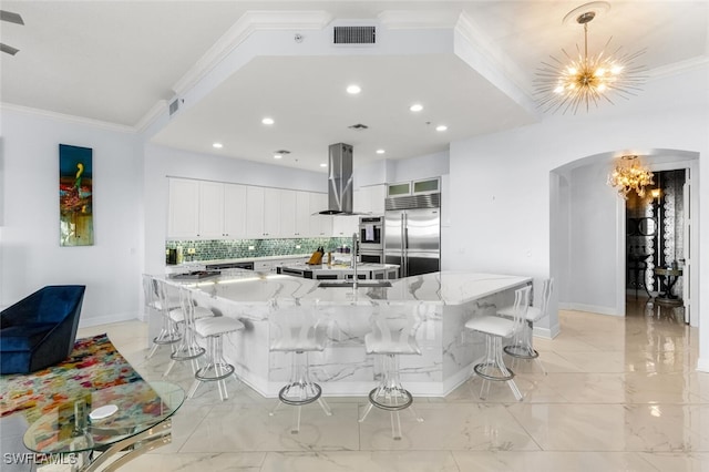 11640 Court Of Palms Unit 602, Fort Myers, FL 33908 - kitchen with a chandelier, arched walkways, backsplash, light stone countertops, and ornamental molding