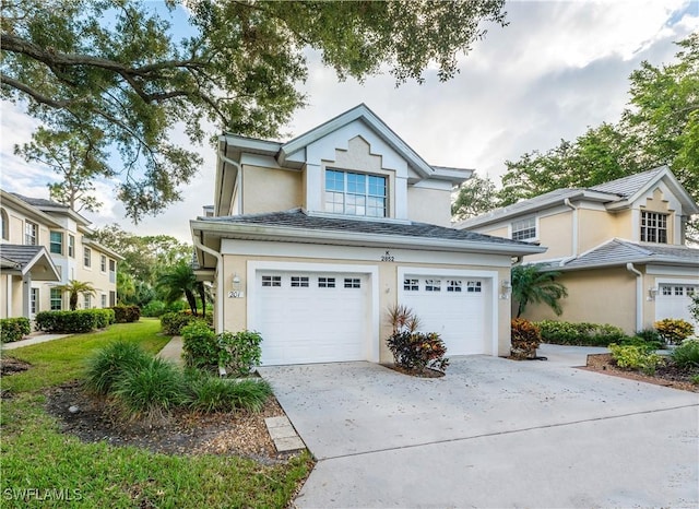 2852 Aintree Ln Unit K201, Naples, FL 34112 - traditional home featuring stucco siding, driveway, and a garage