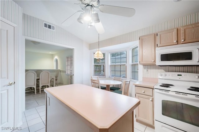 2852 Aintree Ln Unit K201, Naples, FL 34112 - kitchen with white appliances, light tile patterned floors, ceiling fan, light countertops, and wallpapered walls