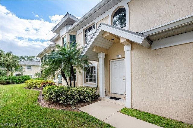 2852 Aintree Ln Unit K201, Naples, FL 34112 - entrance to property with stucco siding and a lawn