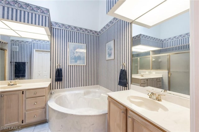 2852 Aintree Ln Unit K201, Naples, FL 34112 - bathroom with wallpapered walls, a garden tub, two vanities, a shower stall, and tile patterned floors