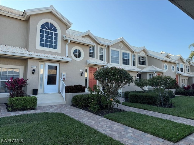 13611 Worthington Way Unit 1307, Bonita Springs, FL 34135 - mediterranean / spanish-style house with stucco siding, a front yard, a tiled roof, and entry steps