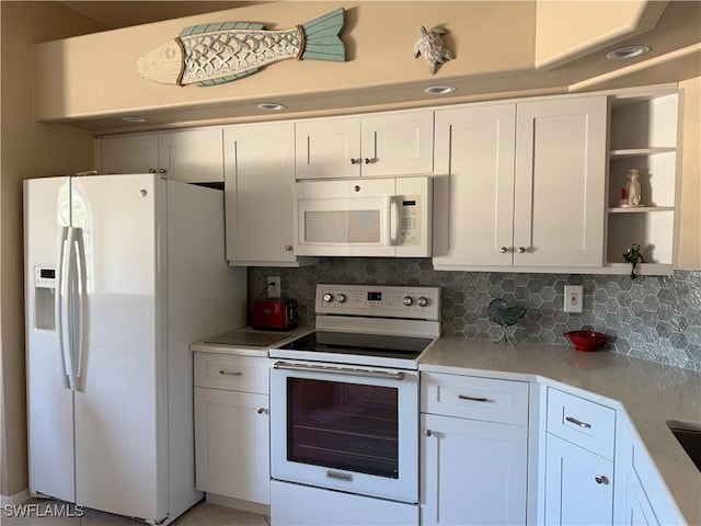 13611 Worthington Way Unit 1307, Bonita Springs, FL 34135 - kitchen with white appliances, light countertops, open shelves, and backsplash