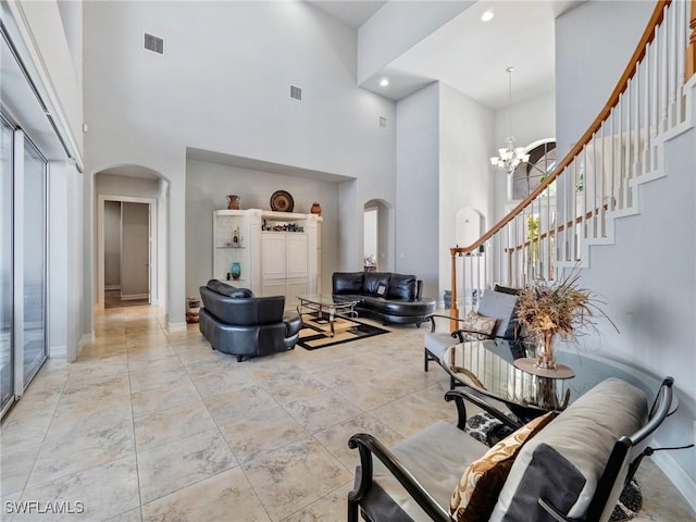 2705 SW 30th Ter, Cape Coral, FL 33914 - foyer featuring arched walkways, a towering ceiling, a chandelier, stairs, and recessed lighting