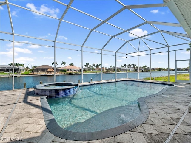 2705 SW 30th Ter, Cape Coral, FL 33914 - view of pool featuring a pool with connected hot tub, a water view, and a lanai