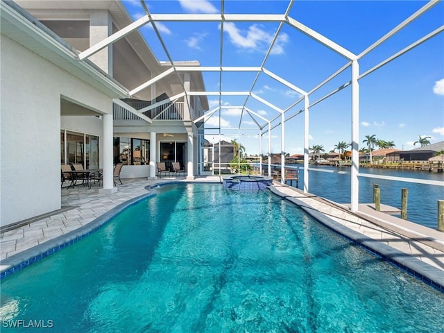 2705 SW 30th Ter, Cape Coral, FL 33914 - view of swimming pool with a patio area, a pool with connected hot tub, a lanai, and a water view
