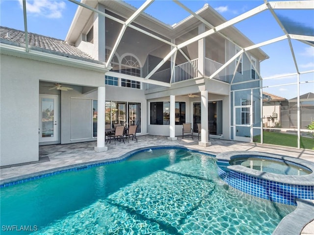 2705 SW 30th Ter, Cape Coral, FL 33914 - view of swimming pool with a ceiling fan, a patio, a pool with connected hot tub, and glass enclosure