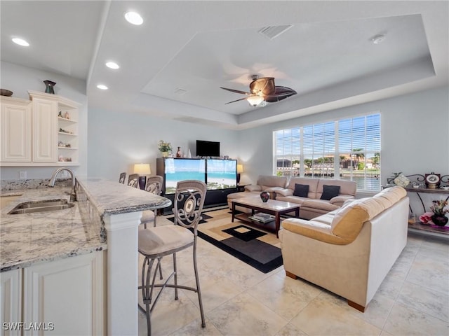 2705 SW 30th Ter, Cape Coral, FL 33914 - living room featuring a raised ceiling, ceiling fan, and recessed lighting