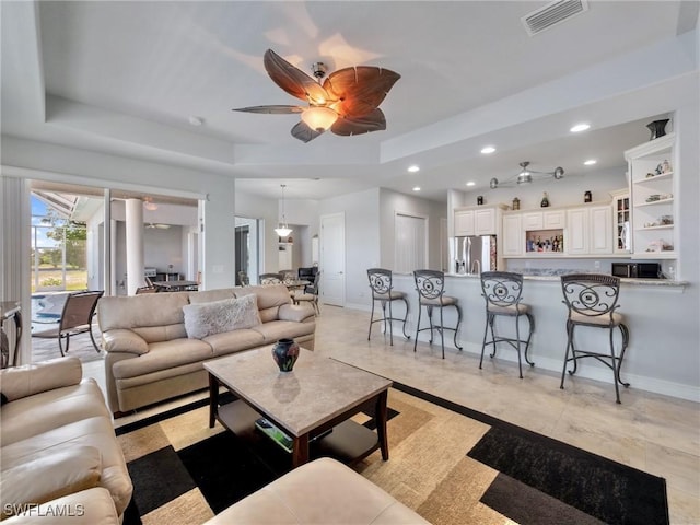 2705 SW 30th Ter, Cape Coral, FL 33914 - living room with a ceiling fan, recessed lighting, and a tray ceiling