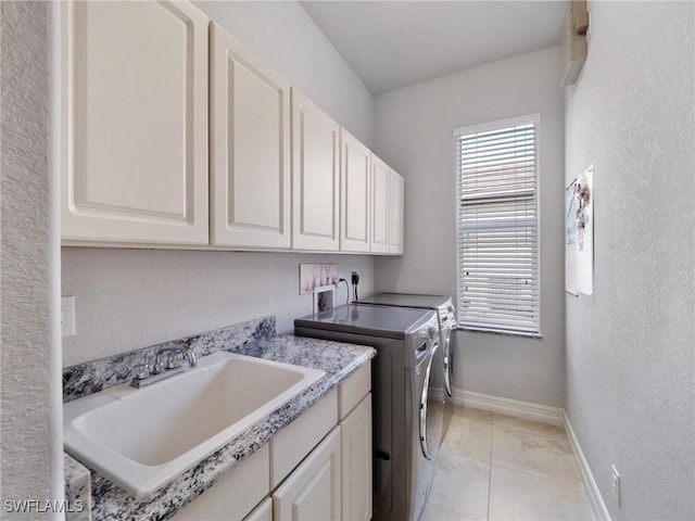 2705 SW 30th Ter, Cape Coral, FL 33914 - laundry room featuring cabinet space, washer and dryer, and a textured wall