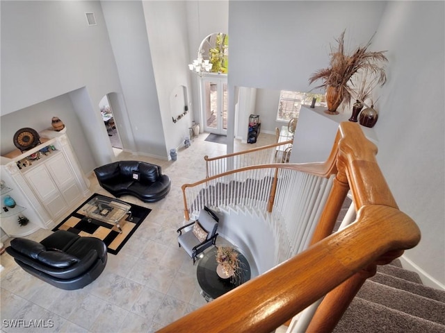 2705 SW 30th Ter, Cape Coral, FL 33914 - stairway with a towering ceiling, arched walkways, and a chandelier