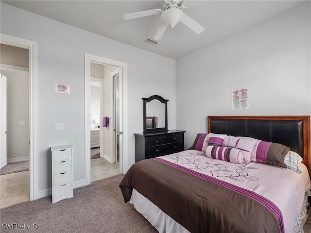 2705 SW 30th Ter, Cape Coral, FL 33914 - bedroom with light tile patterned floors, light colored carpet, ceiling fan, and ensuite bathroom
