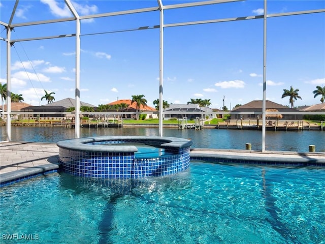 2705 SW 30th Ter, Cape Coral, FL 33914 - view of swimming pool with a pool with connected hot tub, a residential view, and a water view