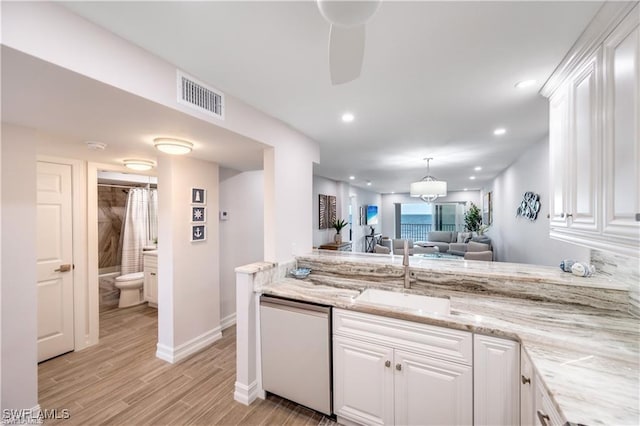 26000 Hickory Blvd Unit 205, Bonita Springs, FL 34134 - kitchen with a ceiling fan, dishwashing machine, white cabinets, light wood finished floors, and open floor plan