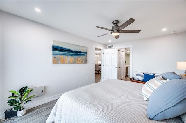 26000 Hickory Blvd Unit 205, Bonita Springs, FL 34134 - bedroom featuring wood finished floors, recessed lighting, a ceiling fan, and connected bathroom