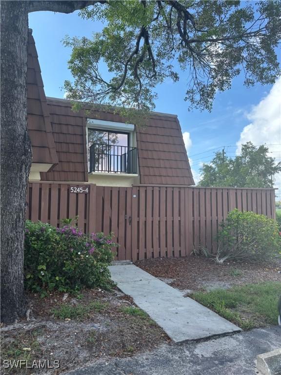 5245 Cedarbend Dr Unit 4, Fort Myers, FL 33919 - view of home's exterior featuring mansard roof