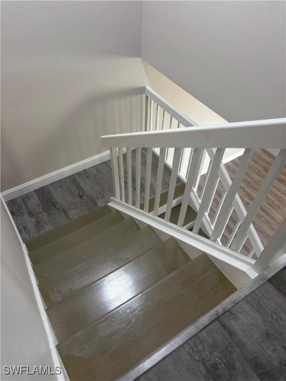 5245 Cedarbend Dr Unit 4, Fort Myers, FL 33919 - stairway featuring wood finished floors