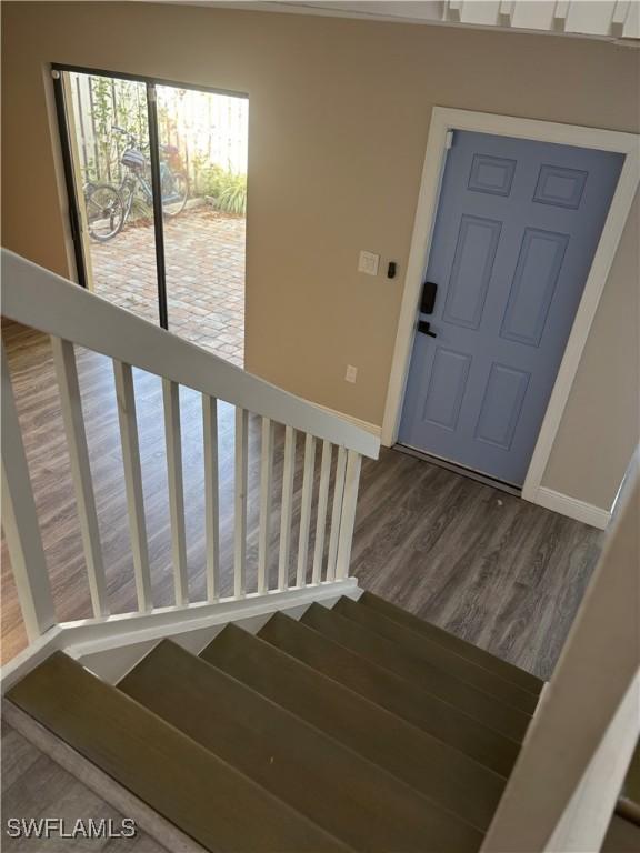 5245 Cedarbend Dr Unit 4, Fort Myers, FL 33919 - staircase with baseboards and wood finished floors