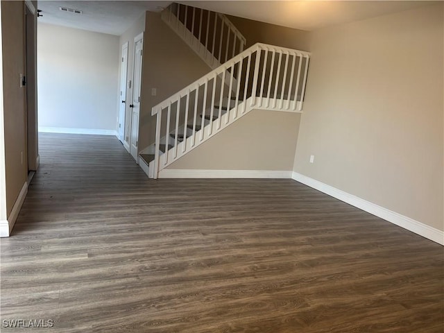 5245 Cedarbend Dr Unit 4, Fort Myers, FL 33919 - unfurnished living room featuring stairs and dark wood finished floors