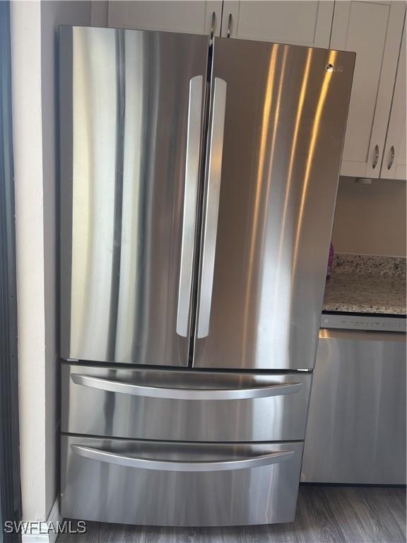 5245 Cedarbend Dr Unit 4, Fort Myers, FL 33919 - detailed view of appliances with stainless steel finishes and wood finished floors