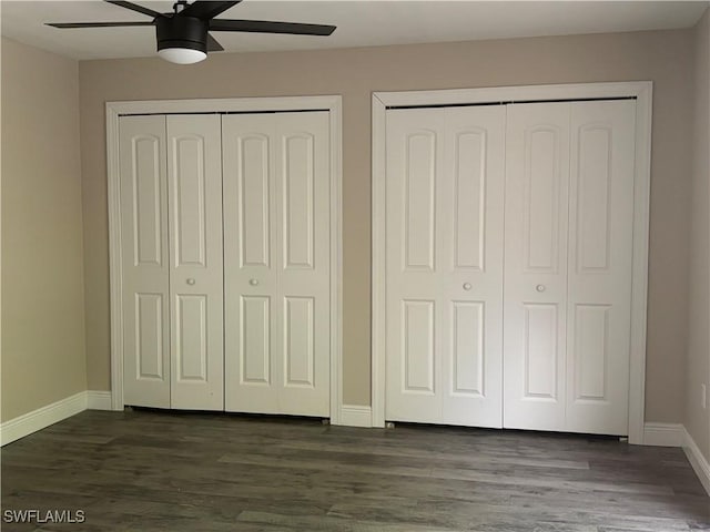 5245 Cedarbend Dr Unit 4, Fort Myers, FL 33919 - unfurnished bedroom featuring two closets, dark wood-style flooring, and ceiling fan