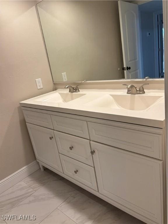 5245 Cedarbend Dr Unit 4, Fort Myers, FL 33919 - bathroom with double vanity and marble look tile flooring