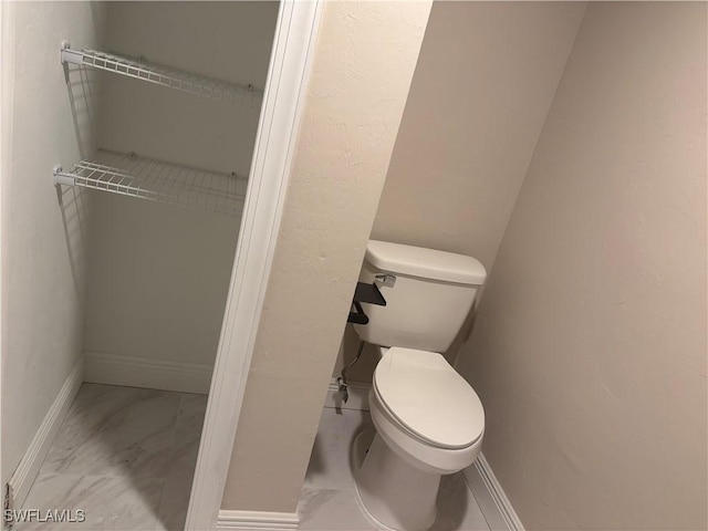 5245 Cedarbend Dr Unit 4, Fort Myers, FL 33919 - bathroom with toilet and marble look tile flooring