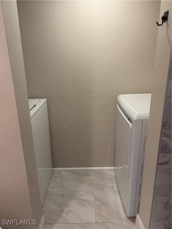 5245 Cedarbend Dr Unit 4, Fort Myers, FL 33919 - laundry area with separate washer and dryer and light marble finish floors