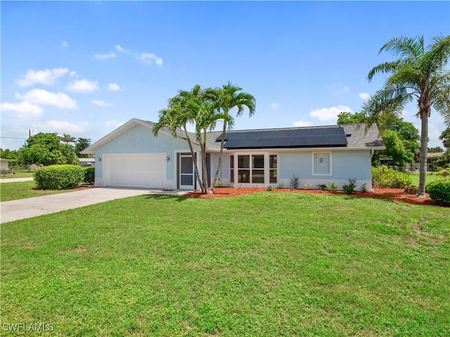 505 Monterey Ave, Cape Coral, FL 33904 - single story home featuring an attached garage, stucco siding, driveway, roof mounted solar panels, and a front lawn