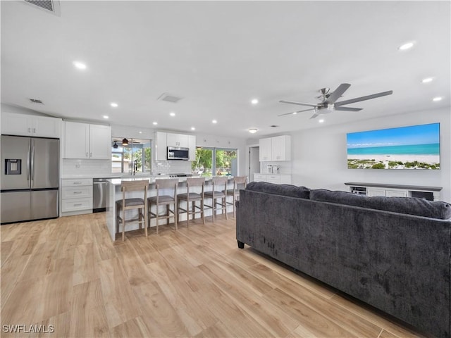 505 Monterey Ave, Cape Coral, FL 33904 - living area featuring ceiling fan, light wood-style floors, and recessed lighting