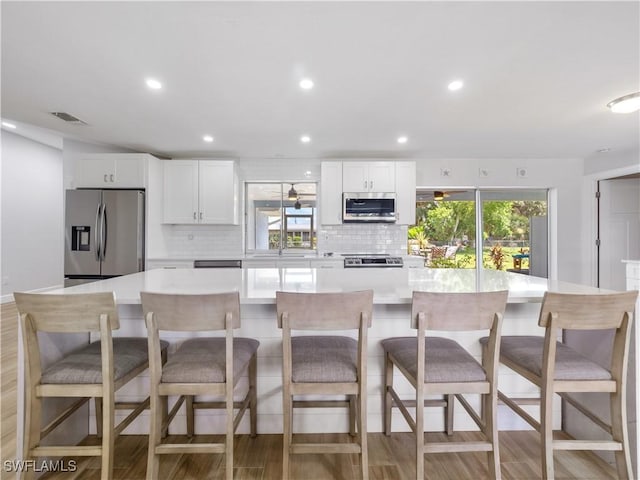 505 Monterey Ave, Cape Coral, FL 33904 - kitchen featuring appliances with stainless steel finishes, decorative backsplash, light countertops, white cabinets, and recessed lighting